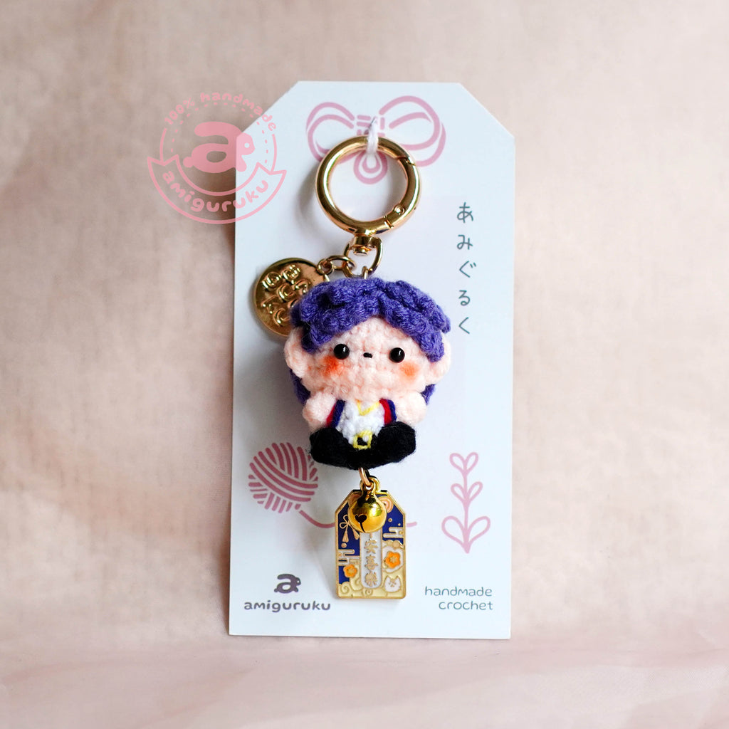 Keychain with a character on a white tag against a beige background