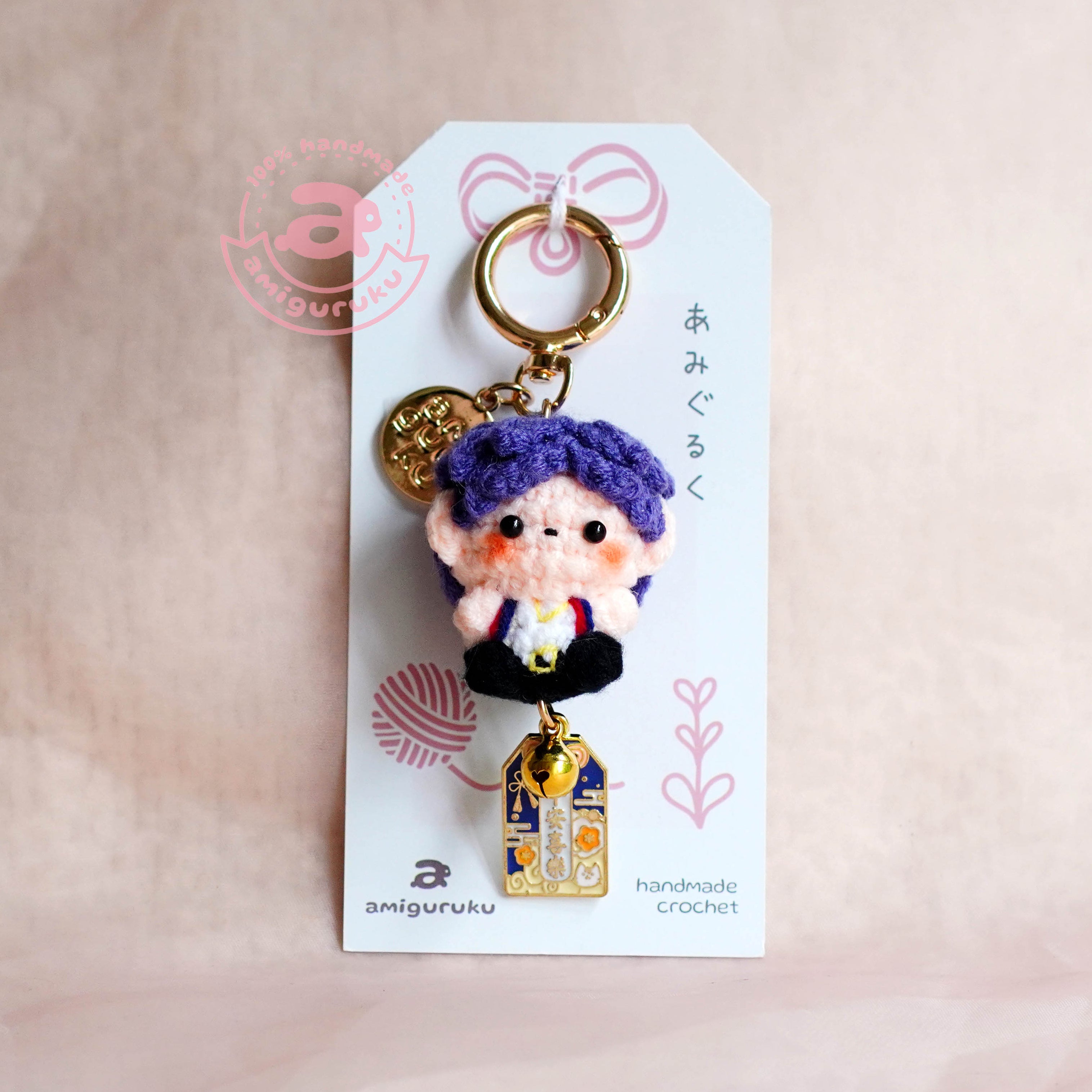 Keychain with a character on a white tag against a beige background
