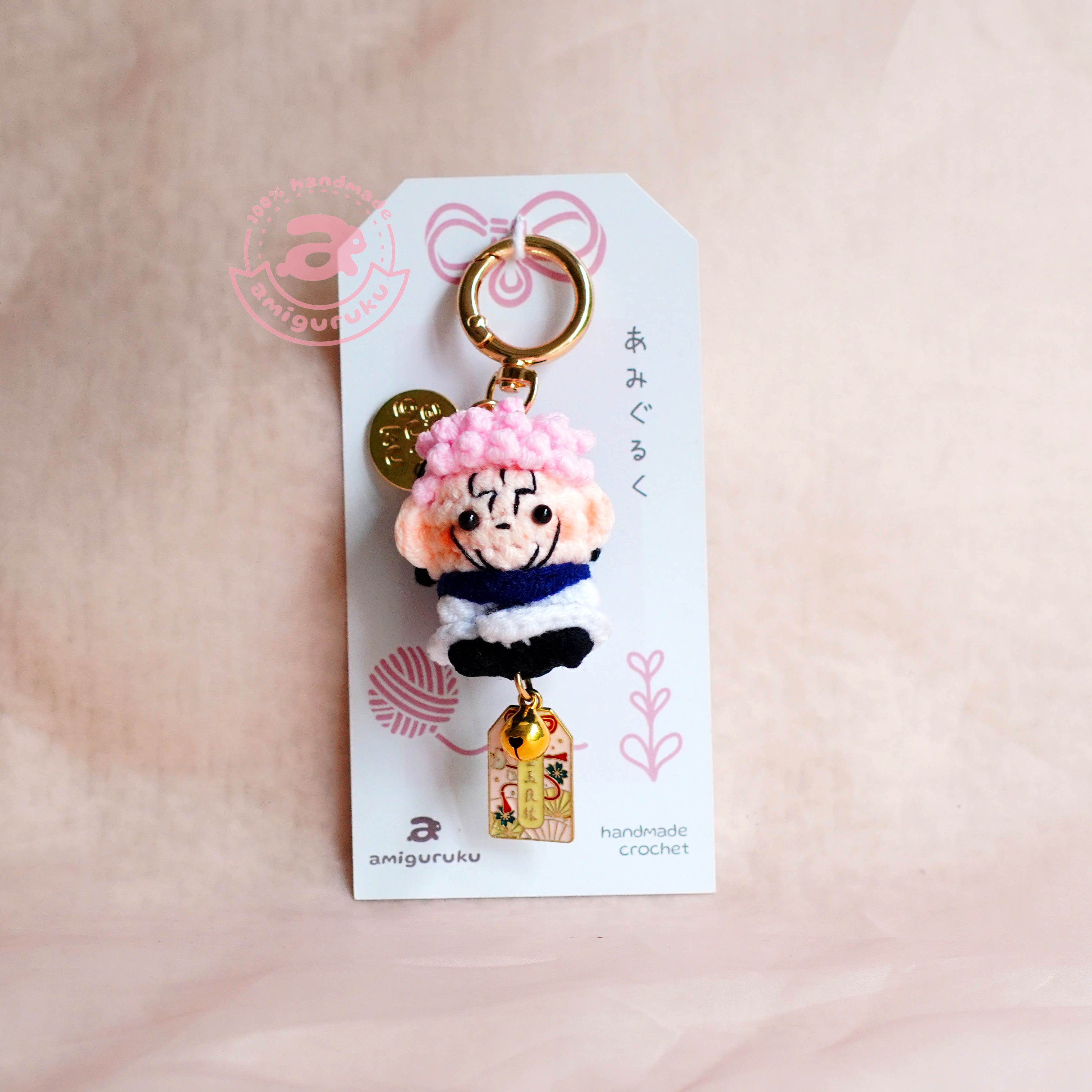 Ryomen Sukuna Keychain with cartoon character on a white card against a beige background