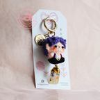 Amigurumi keychain with a tag on a light pink background