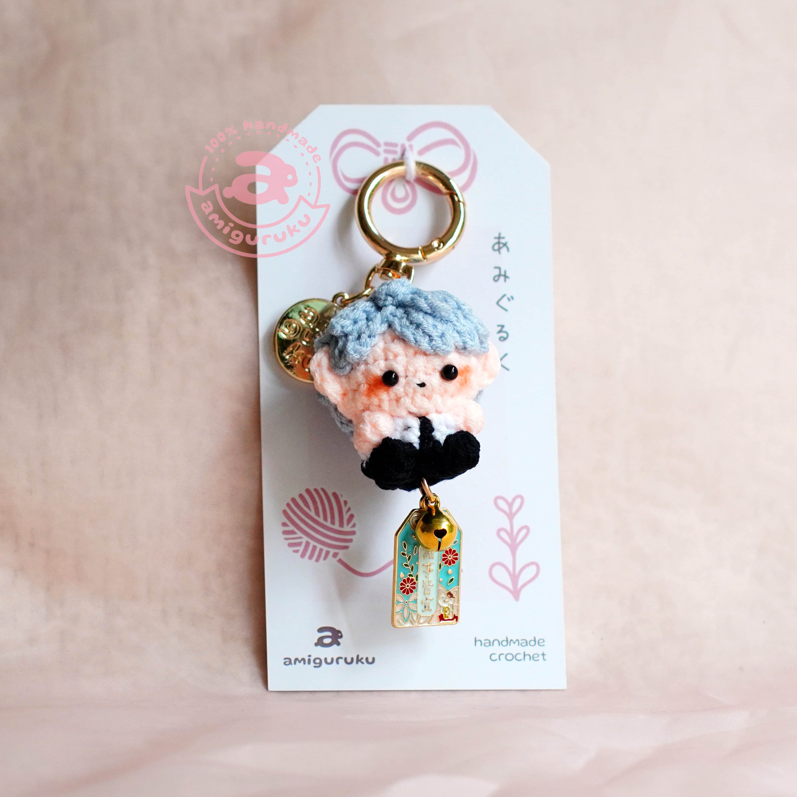 Keychain with a character on a white card against a beige background