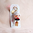 Keychain with a character on a pink background